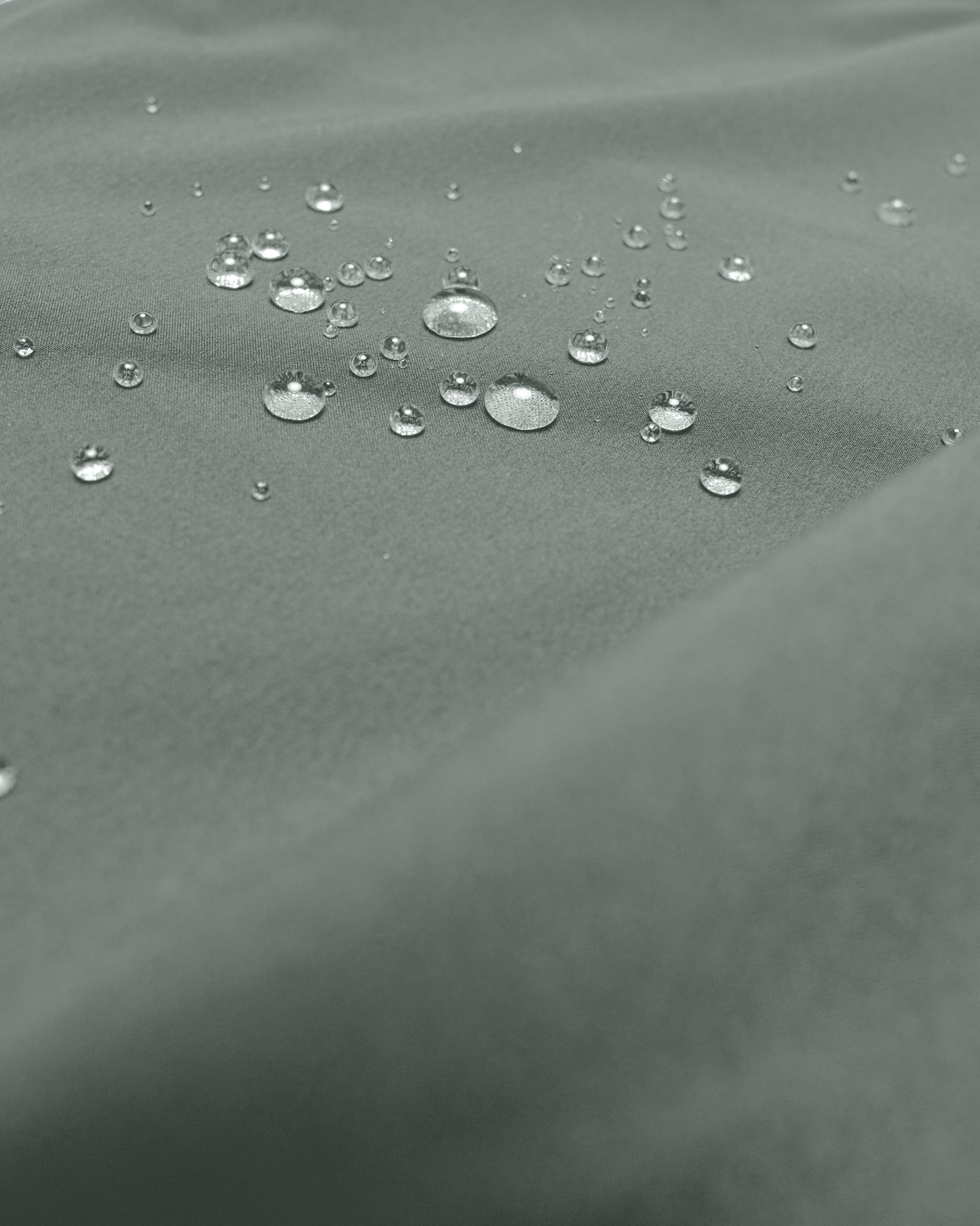 Close-up of a textured mint green fabric with water droplets on the surface - Bamboo Ave