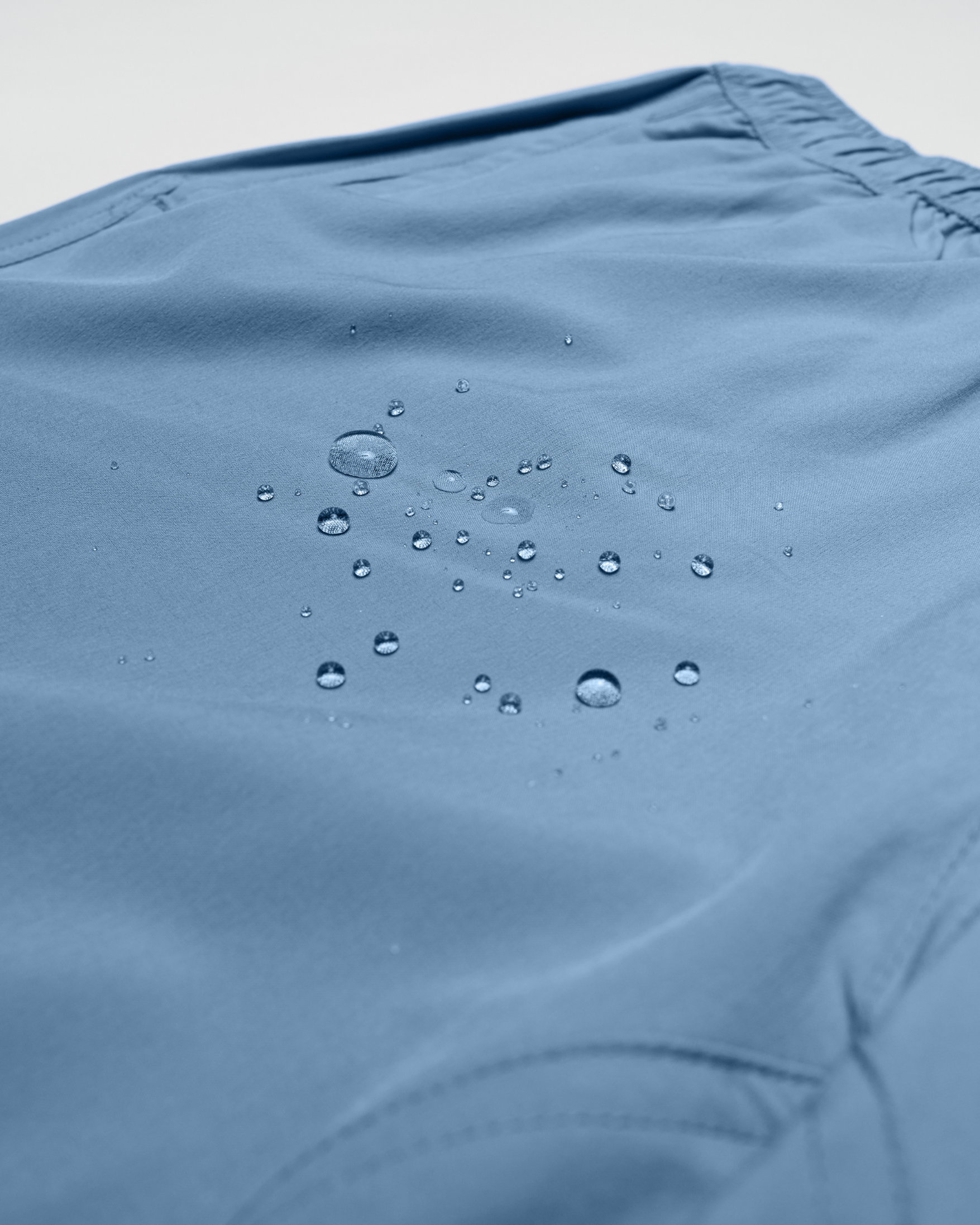 Light blue shorts with water droplets on the fabric, showcasing a smooth texture. - Bamboo Ave