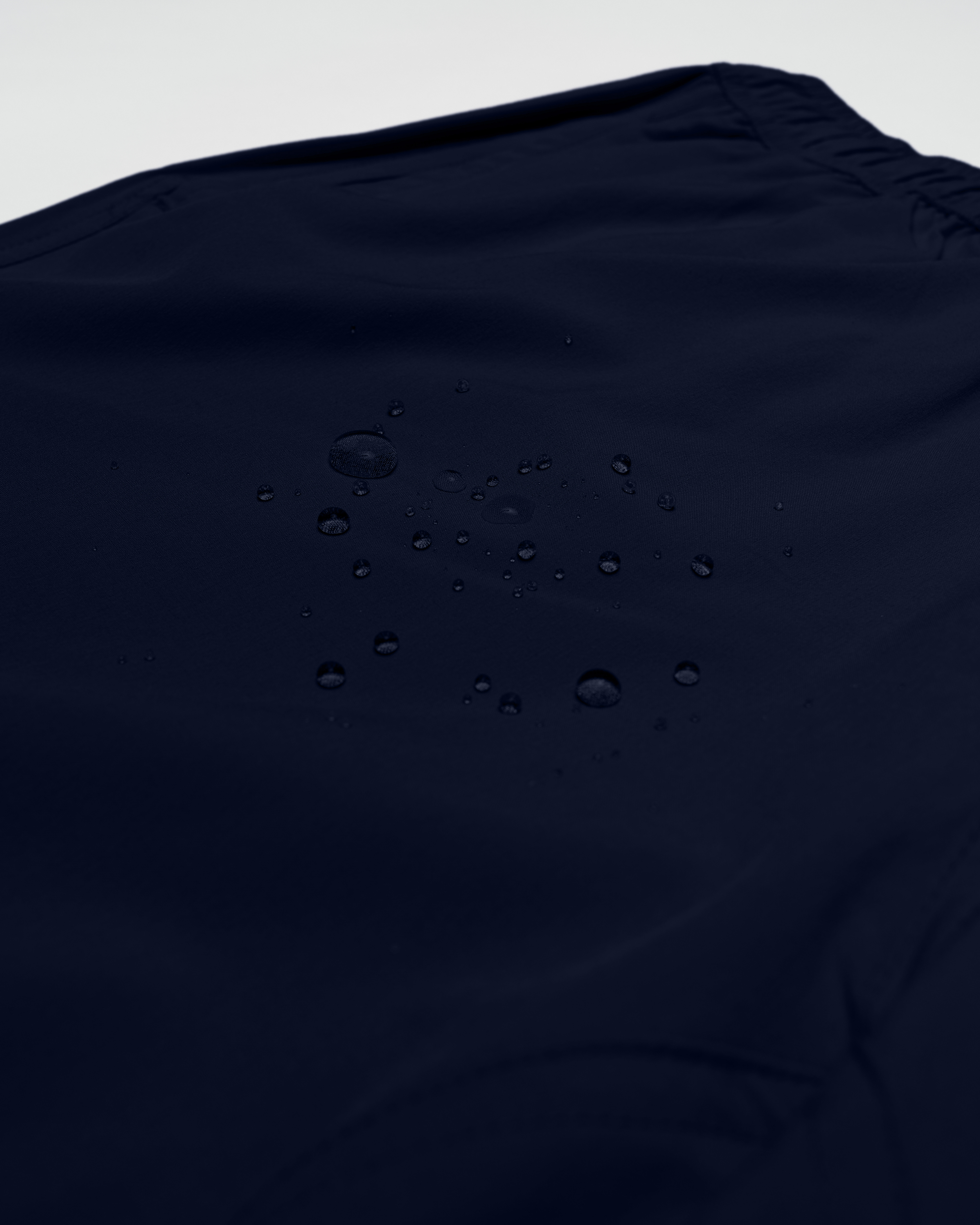Navy blue shorts with a smooth texture and water droplets on the fabric - Bamboo Ave