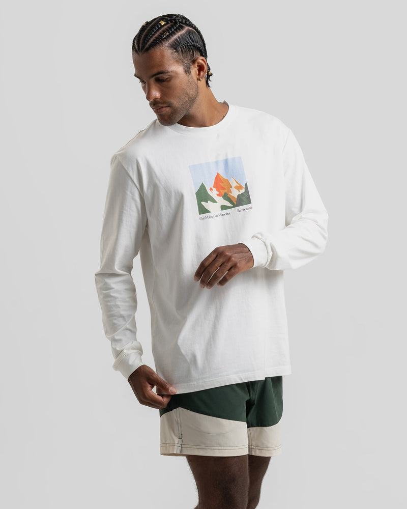 White long sleeve shirt with a colorful mountain graphic, paired with green shorts - Bamboo Ave